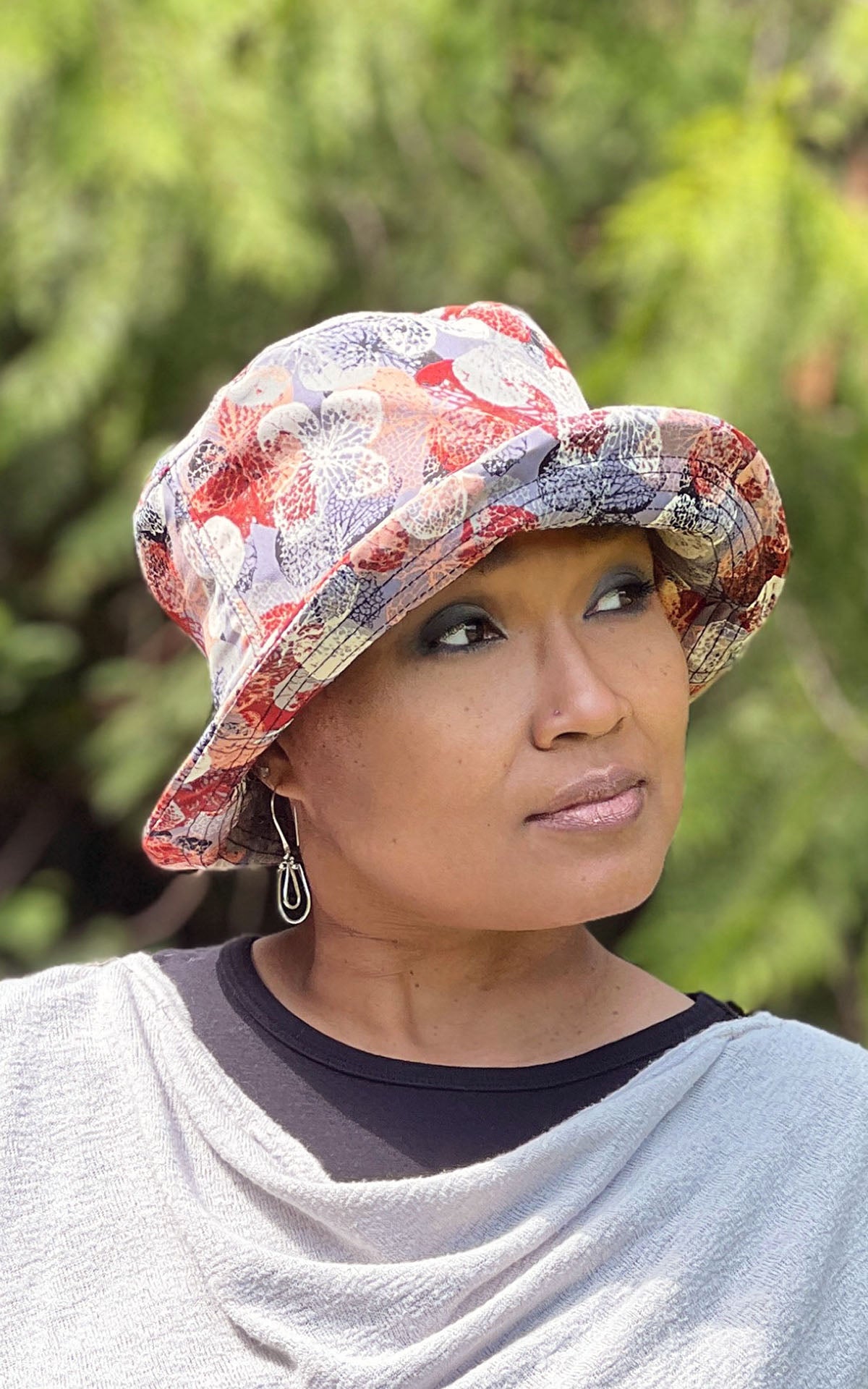 Modeling wearing Hollie Sun Hat in Paper Flowers in Paprika.  Handmade in America by Pandemonium Seattle.  