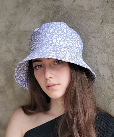Side angle shot of model wearing Hollie Bucket Hat in Leafy. Pandemonium is Handmade in America.