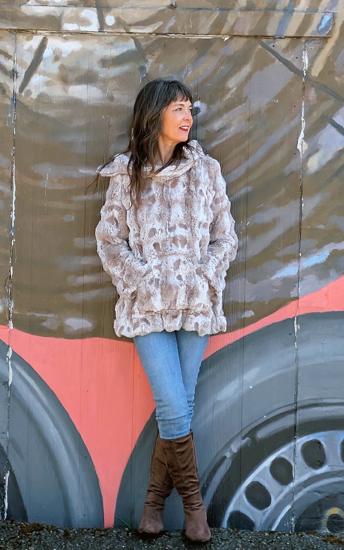 Model leaning on mural wearing Hooded Lounger | Cloudwalk in Honey Faux Fur | Hood Down View |Handmade in Seattle WA | Pandemonium Millinery