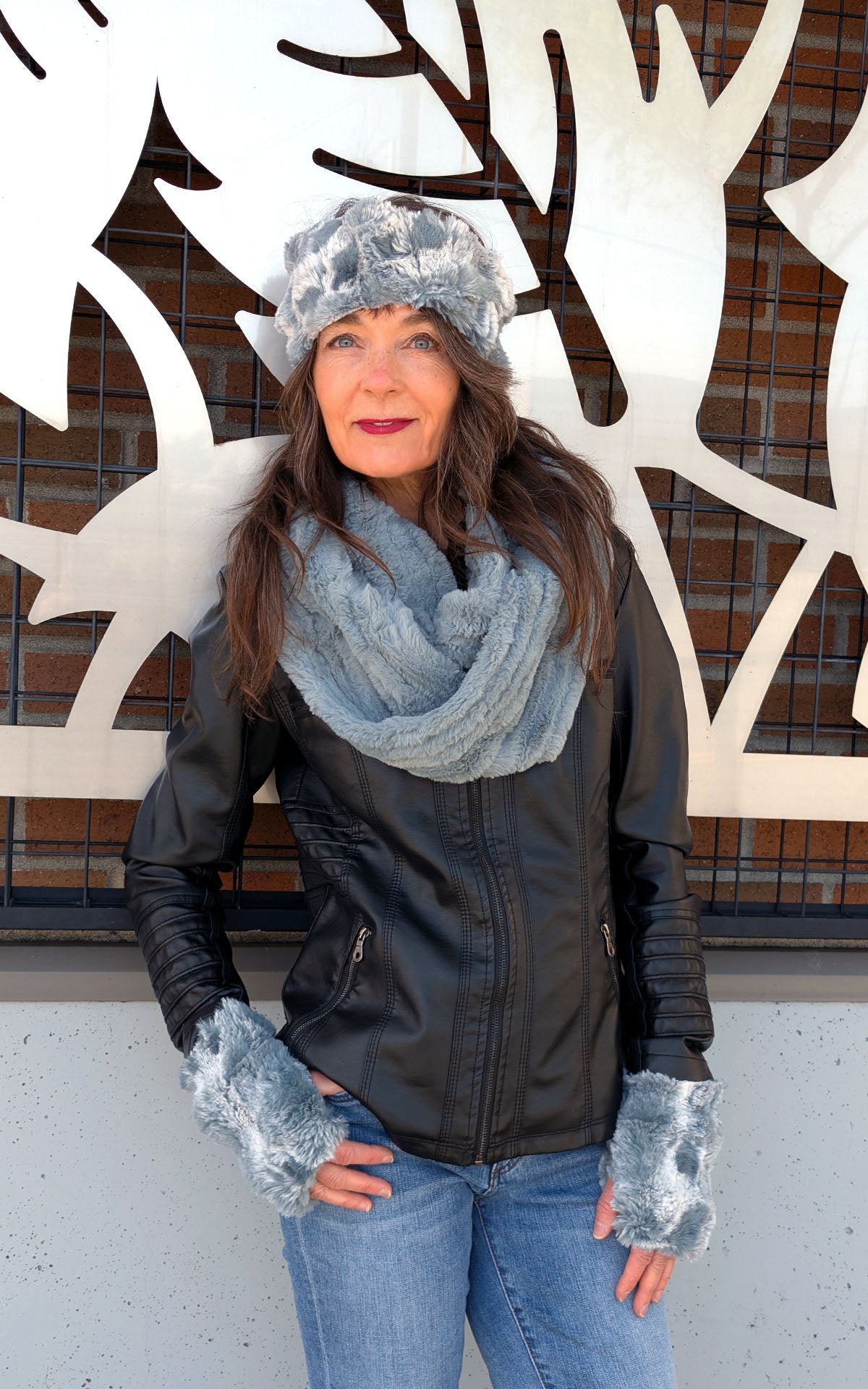Model standing against Mural wearing Fingerless Gloves | Cloudwalk Blue Mist | Also Matching Headband with Infinity Scarf in Cirrus Blue Mist | Handmade in Seattle WA  USA | By Pandemonium Seattle