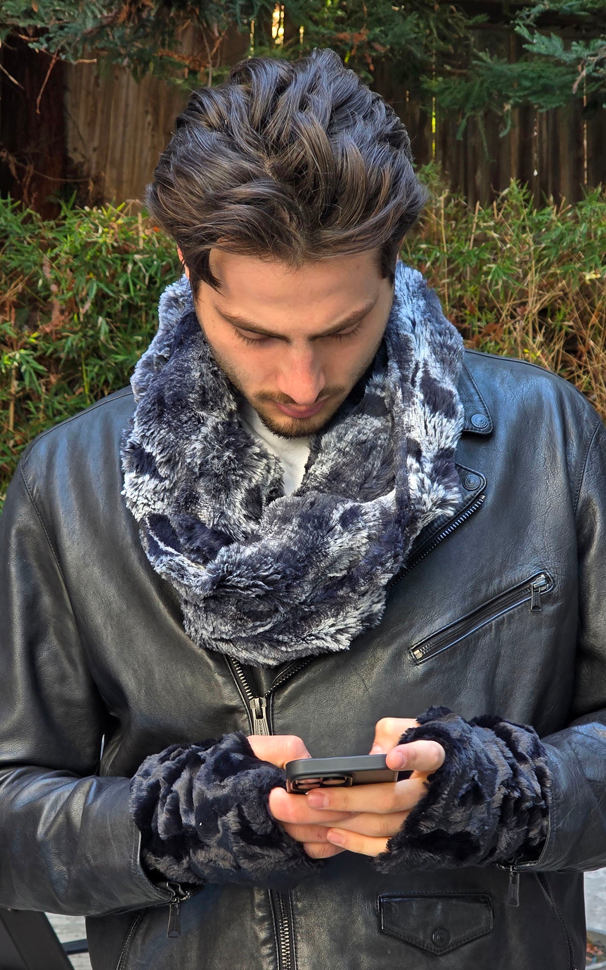 Model wearing Men&#39;s Fingerless Gloves  Texting on Cell Phone | Cuddly Faux Fur in Black | Pandemonium Seattle | Handsewn in Seattle, WA