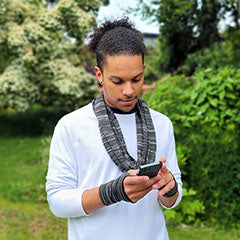 man wearing an infinity scarf and gloves while texting - accessories from Pandemonium Millinery USA
