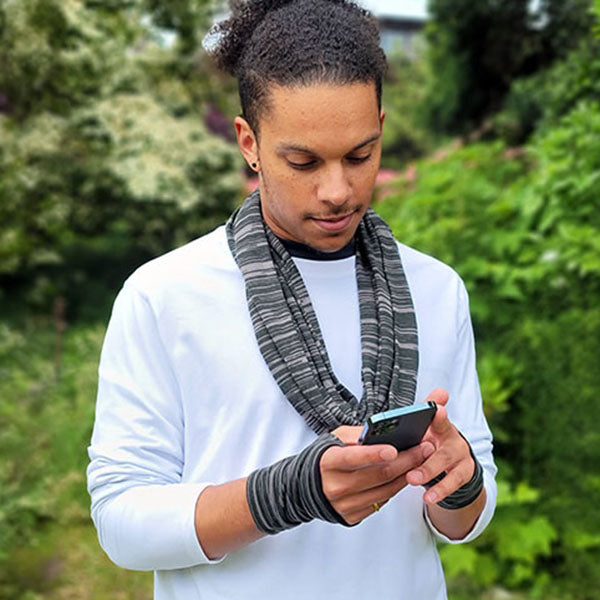 Close-up of a person wearing lightweight, handmade fingerless gloves in a soft, breathable fabric, ideal for transitional spring and summer weather.