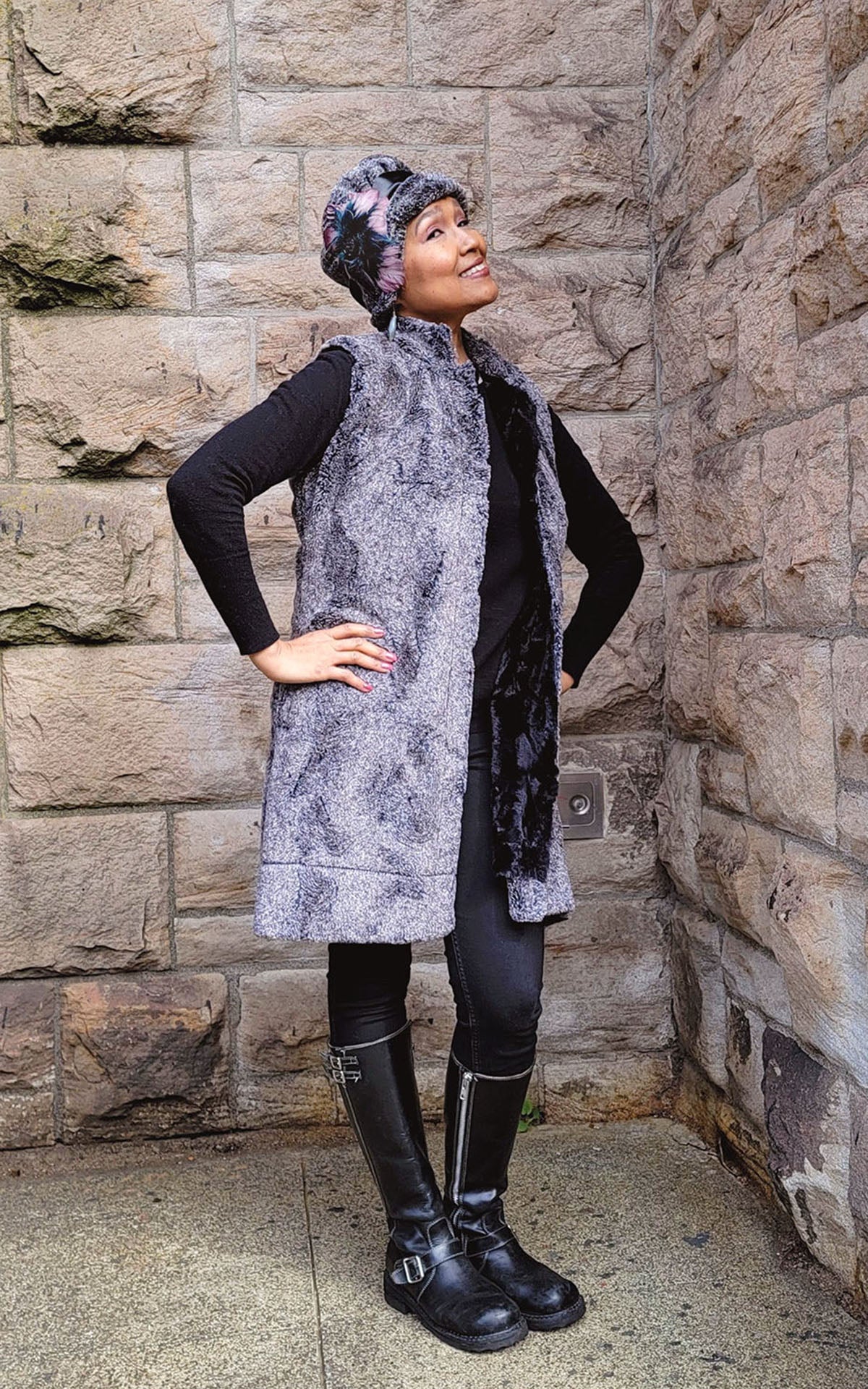 Woman modeling Mandarin Vest in Nimbus and Cuddly Black Faux Fur by stone wall. Handmade in Seattle, WA, USA.