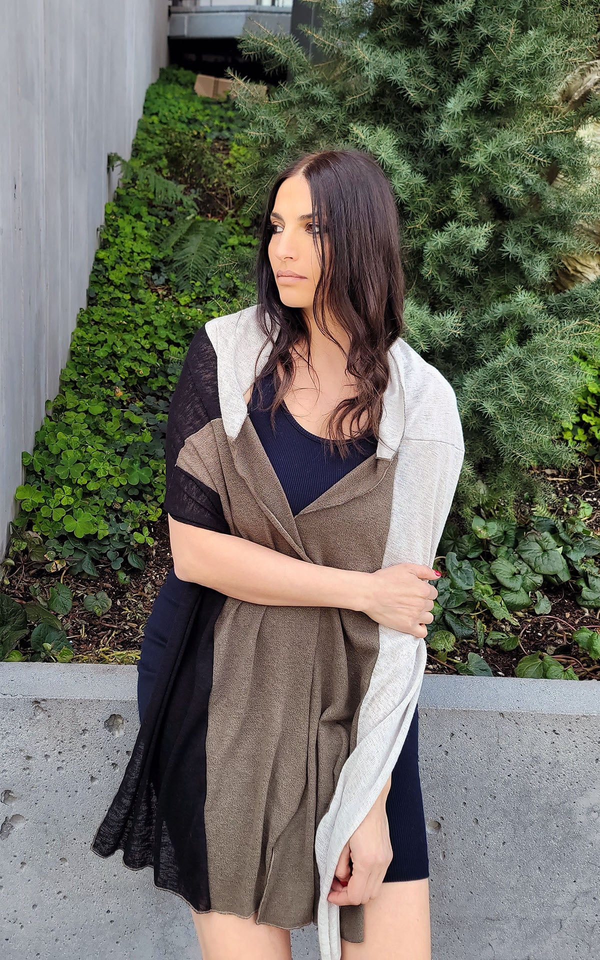 Model wearing Valerie cap hat and Upcycled Motley Scarf in Mezcal and Sandstone on Woman. Large pattern showing open around neck. Handmade in Seattle, WA.