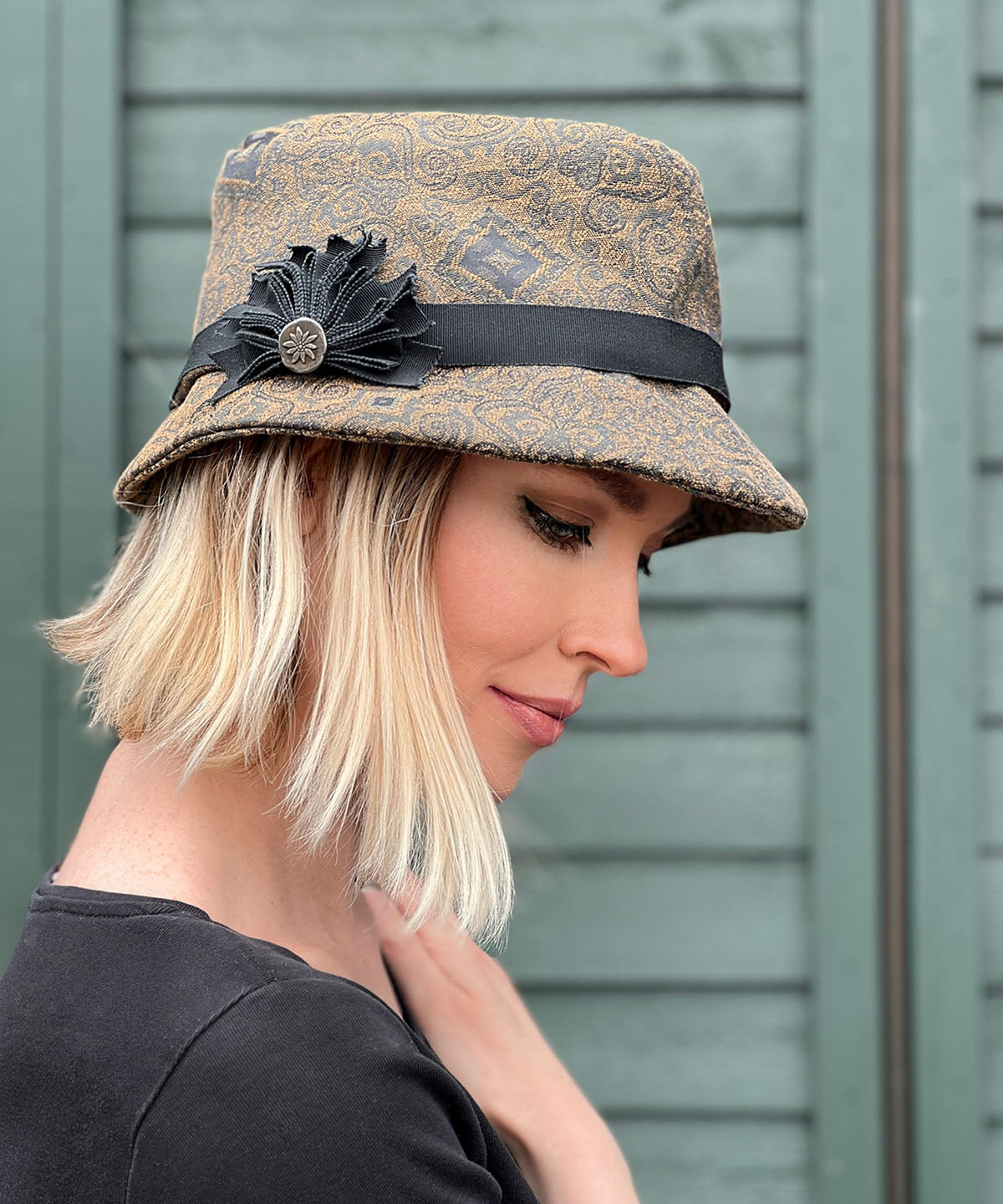 Woman wearing Olivia Fedora Hat in Rubino Upholstery with Custom Grosgrain Brooch | Handmade in Seattle WA | Pandemonium Millinery