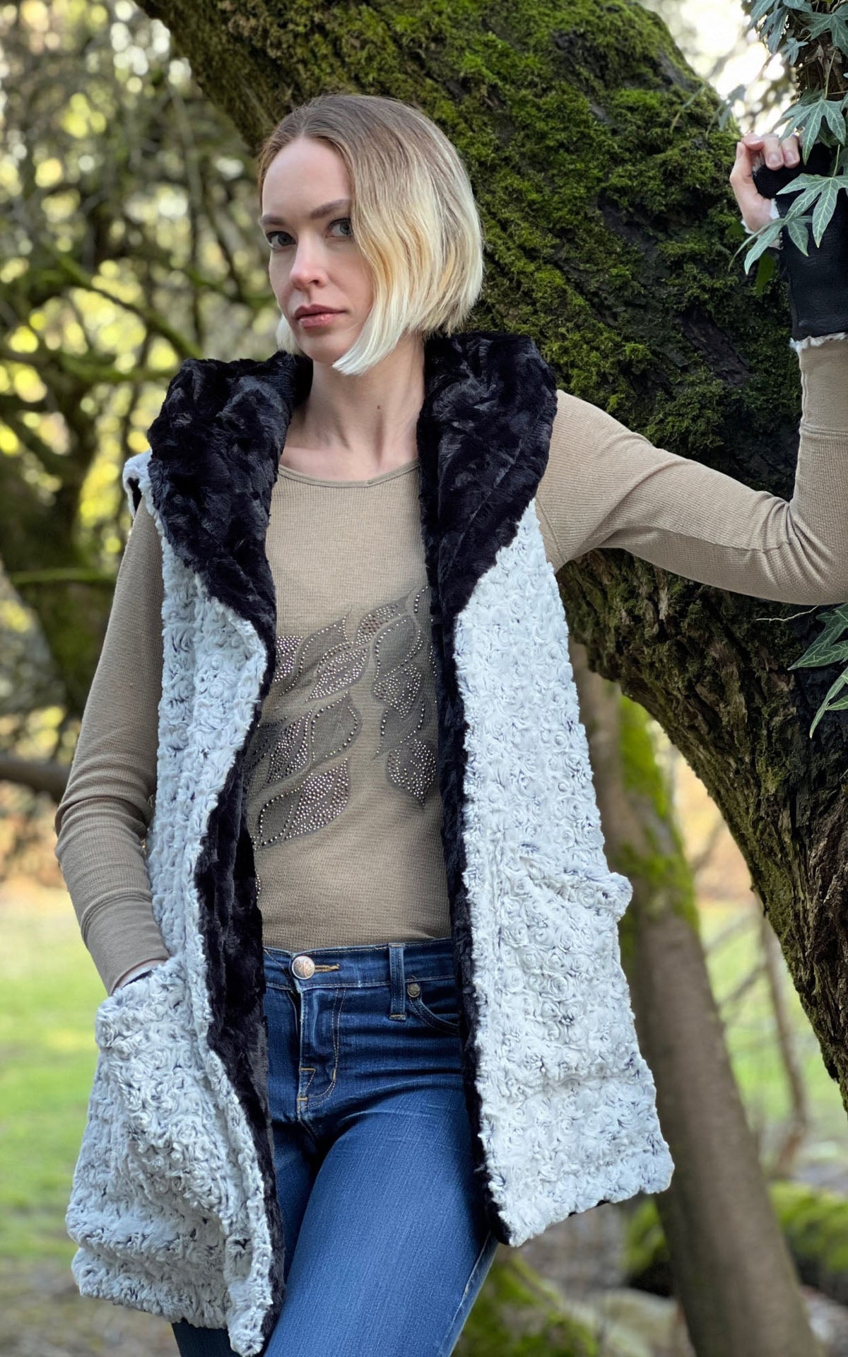 Woman modeling the Oversized Hooded Vest in Rosebud Black Faux Fur with Cuddly Black  on reverse. Handmade by Pandemonium Seattle.