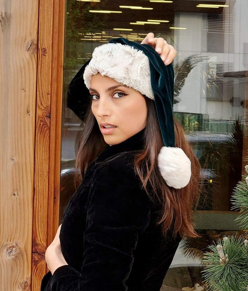 Modeling is wearing Santa Hat Style in Emerald Velvet with Cuddly Sand Faux Fur Cuffs by Pandemonium Seattle. Handmade in Seattle, WA USA.