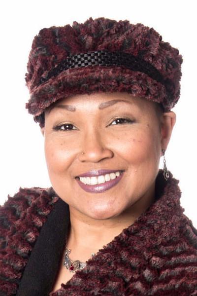 Model is wearing a Valerie Hat Desert Sand in Crimson with Black Band by Pandemonium Millinery. Handmade in Seattle WA USA.