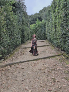 Woman walking in a hedge maze wearing the LYC Roma Top and matching Circle Skirt in Grand Canyon. Made in Seattle, WA, USA by Pandemonium Seattle.
