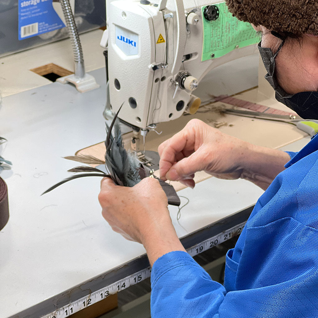 Sewer making feather brooch in house, Handmade Seattle WA, USA by Pandemonium Millinery