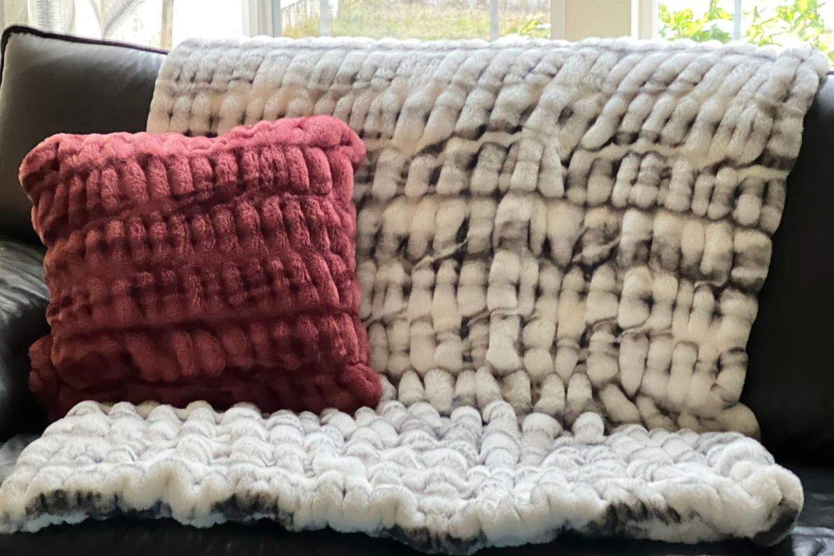 Royal Opulence Throw in Aspen with a throw pillow in Maple Glow. Made by  Pandemonium Seattle.'