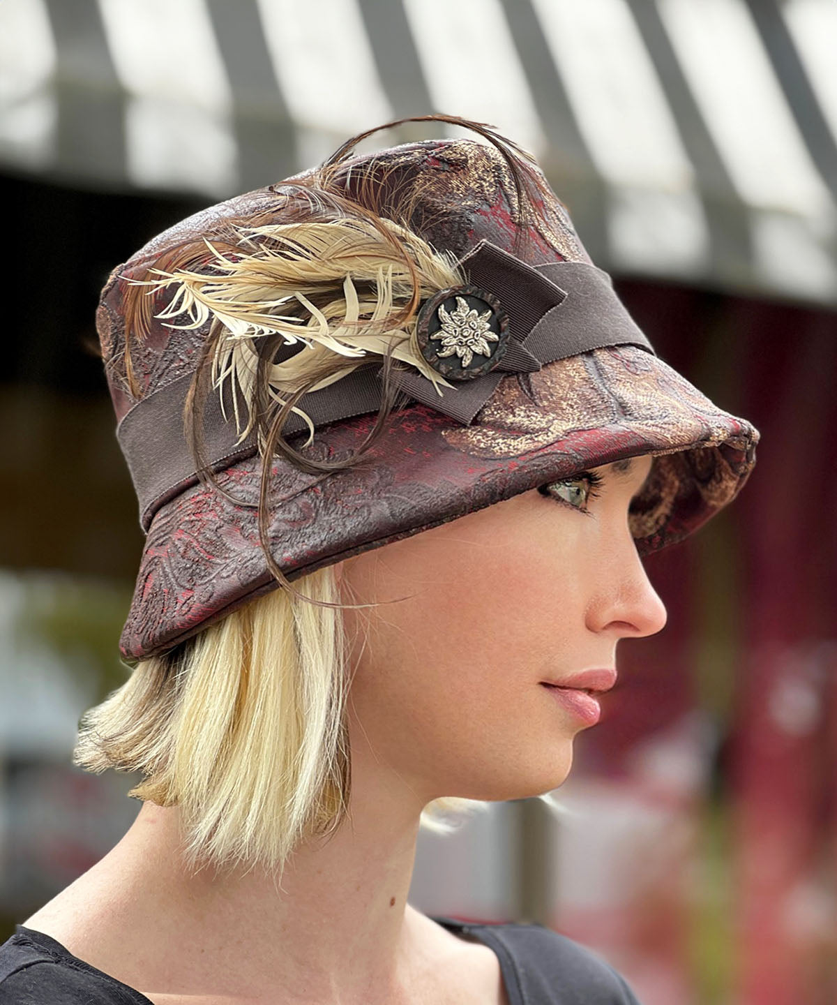 Side View of Samantha Bucket Hat | Renaissance In Ox Blood Upholstery | Feather and Button Brooch | Handmade in Seattle, WA USA by Pandemonium Millinery