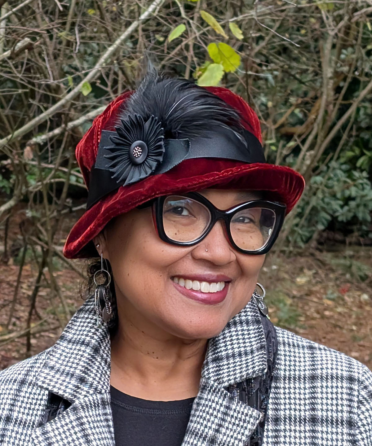 Woman wearing Samantha Hat in Bordeaux Velvet with a Black Grosgrain Band and Medallion with Button and Feathers with cuffed brim | Handmade in Seattle, WA USA | Pandemonium Millinery