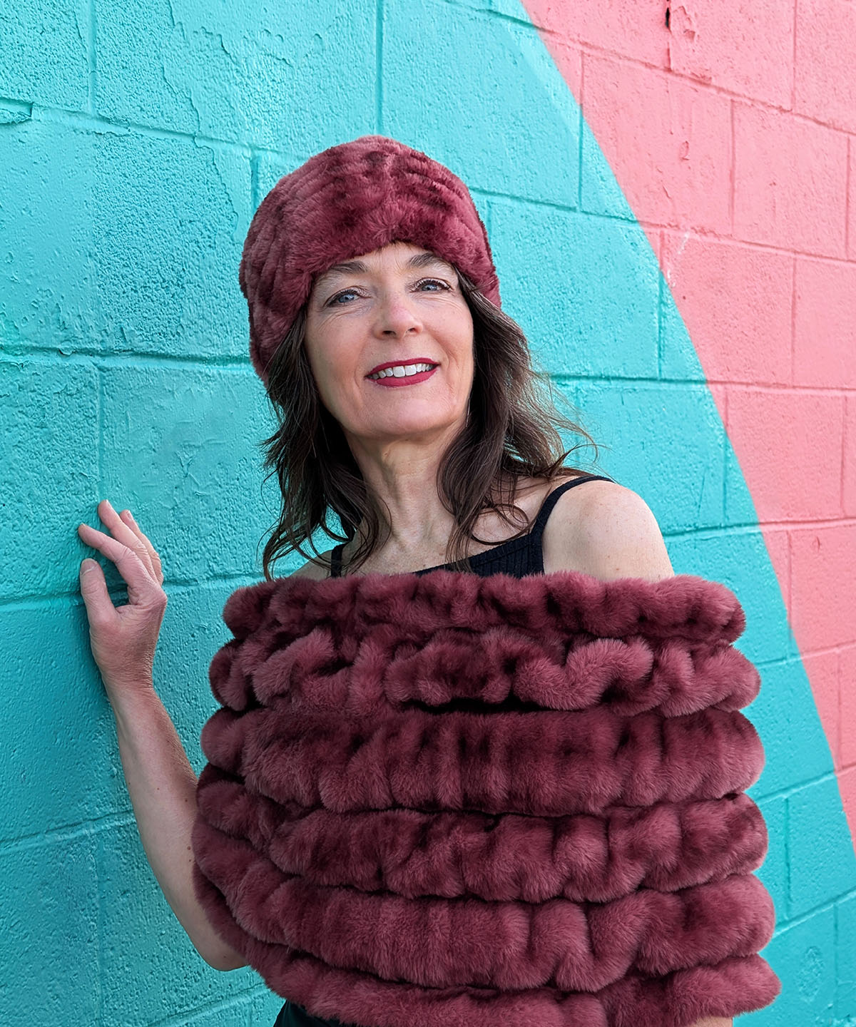 Model smilling wearing Royal Opulence Meadow Glow Faux Fur Shoulder Wrap by Pandemonium Seattle.