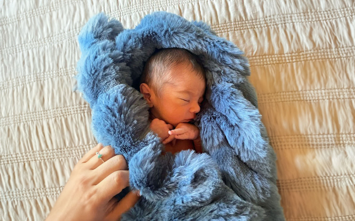 Baby wrapped in Throw Blanket in Bluebell Enchanted Dreams Faux Fur handmade in Seattle WA USA by Pandemonium Millinery