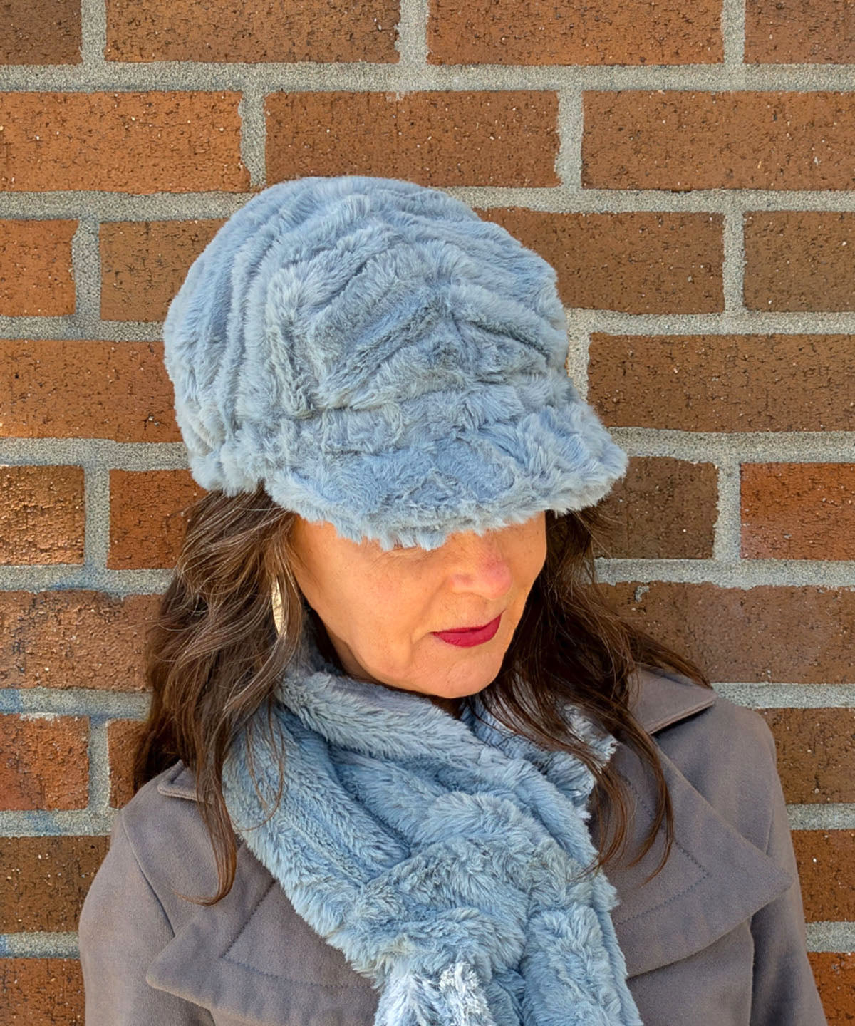 Model Looking down wearing Valerie Hat | Cirrus Faux Fur in Blue Mist |  Handmade in Seattle WA USA | By Pandemonium MIllinery