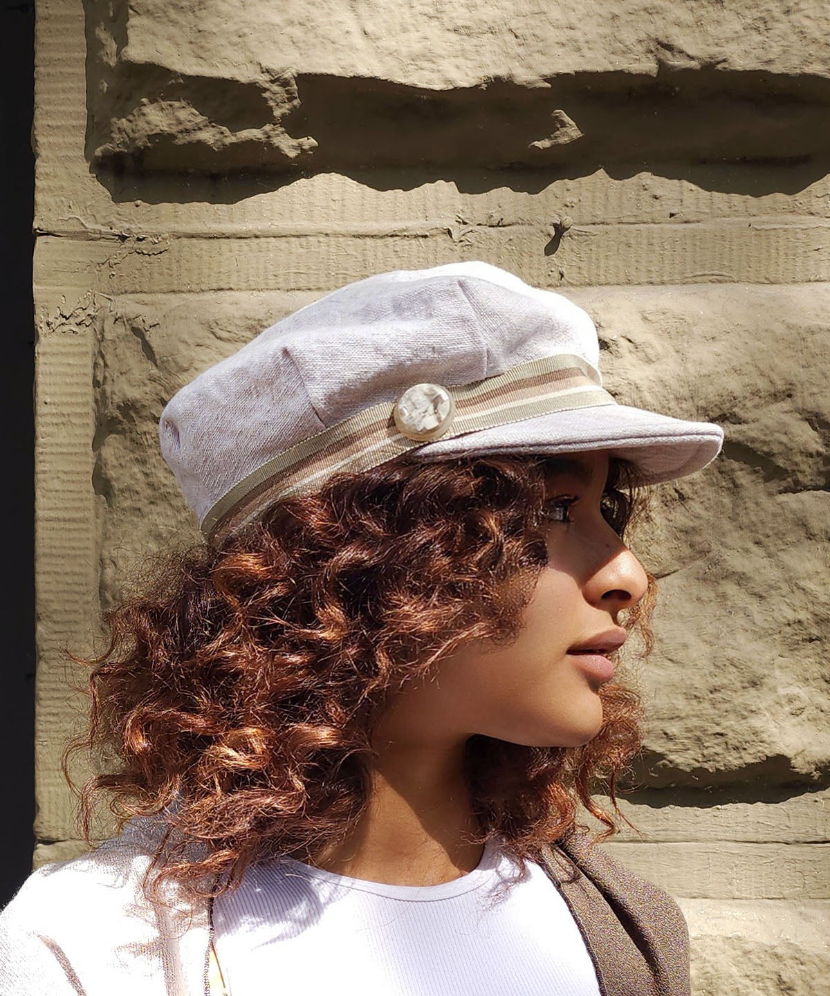 Model wearing Valerie Cap Style Hat in Linen in Bone | Multi-Stripe Band | Handmade by Pandemonium Millinery | Seattle WA