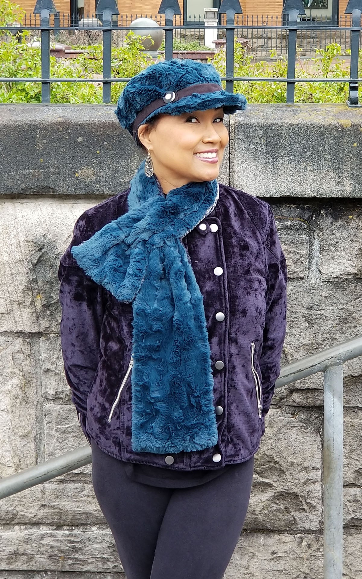 Model wearing Ladies reversible Long Pull Through Scarf | Peacock Pond faux fur, blue turquoise with cuddly fur in black | Handmade in Seattle WA | Pandemonium Millinery