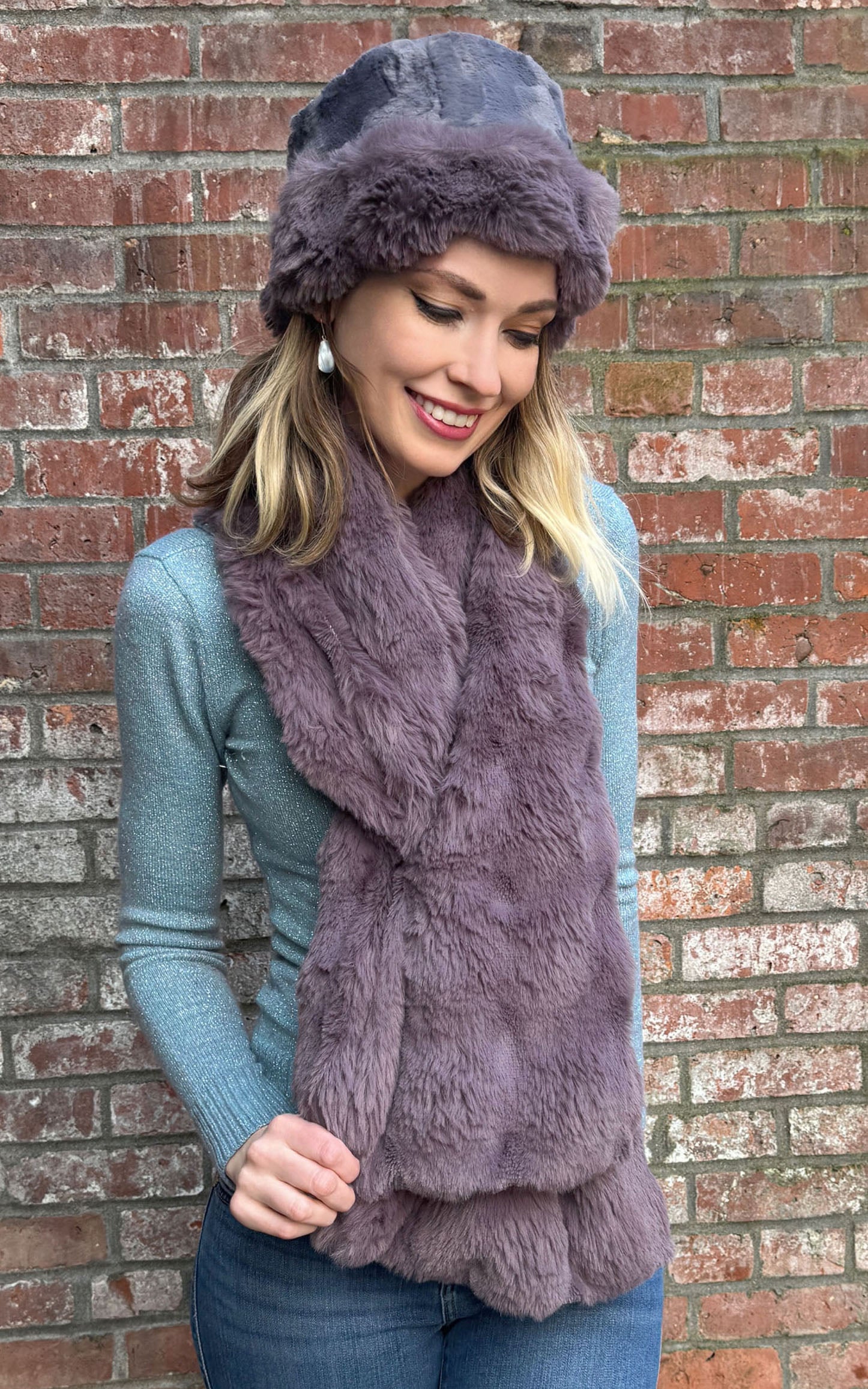 Model standing in front of brick wall wearing a Cuffed Pillbox and Wide Infinity Scarf in Sugar Plum Enchanted Dreams Faux Fur handmade in Seattle WA by Pandemonium Millinery