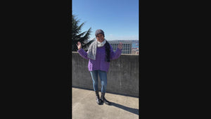 Video of Women in front of the Seattle skyline wearing cuffed pillbox hat and matching  the Color Block Scarf | Winter River, Highland in Skye, and Winter Forst Faux Fur a mix of creams, blues, whites, and Chocolates | Handmade in Seattle WA Pandemonium Millinery