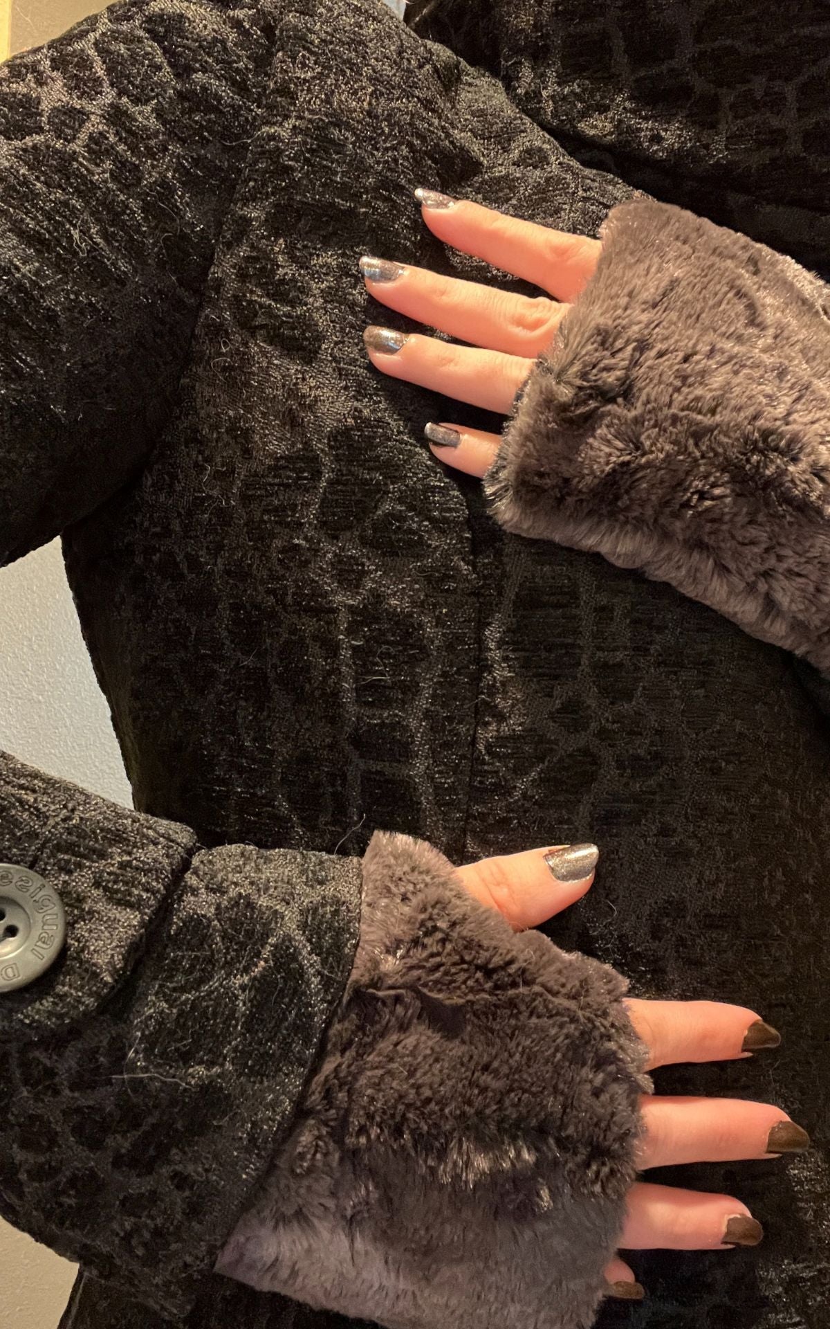 Woman wearing a black coat with Espresso Bean Faux Fur Fingerless Gloves. Made in Seattle, WA, USA. Pandemonium Seattle.