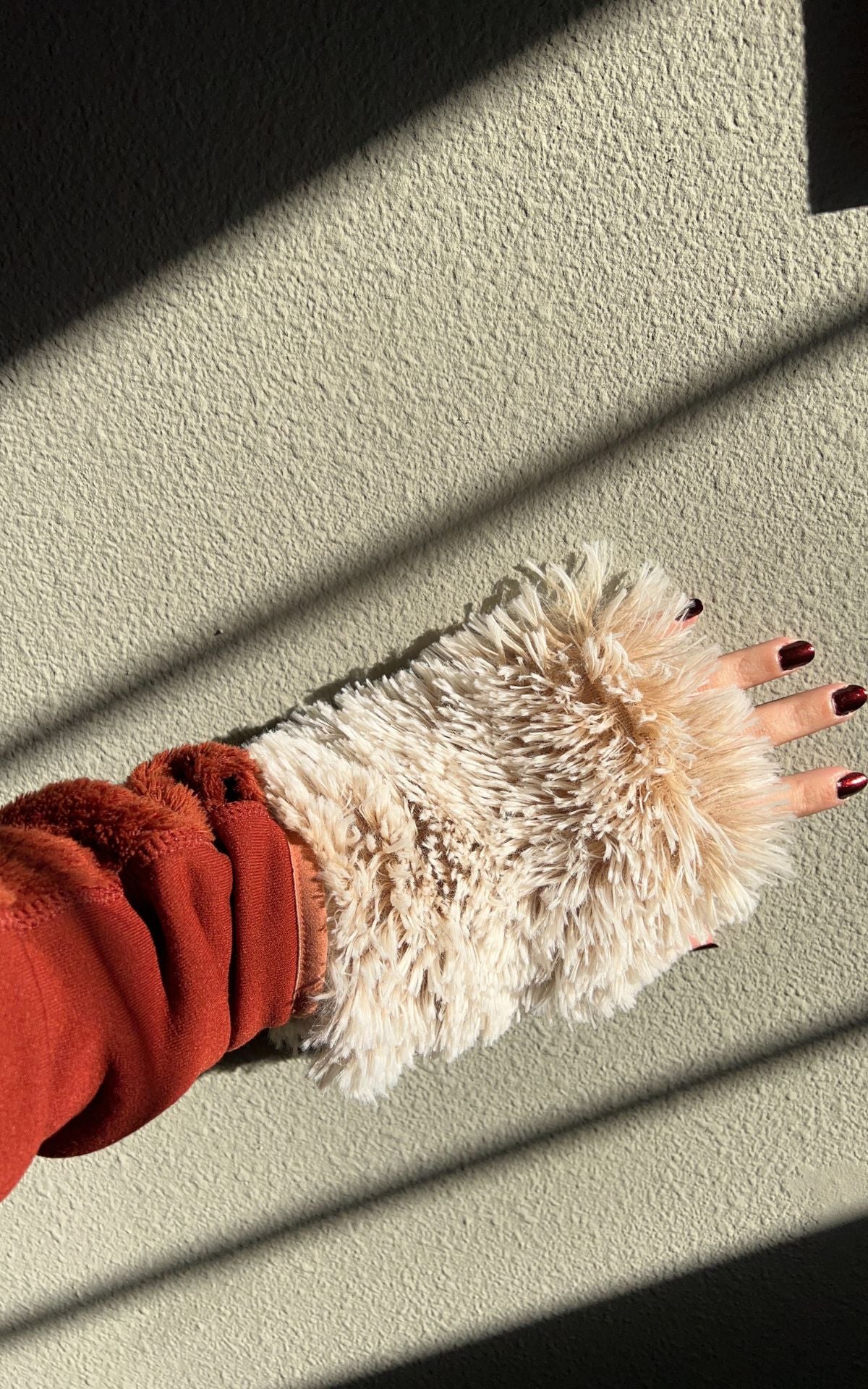 Woman&#39;s hand wearing a Foxy Beach Faux Fur Fingerless Glove. Made in Seattle, WA, USA. Pandemonium Seattle.