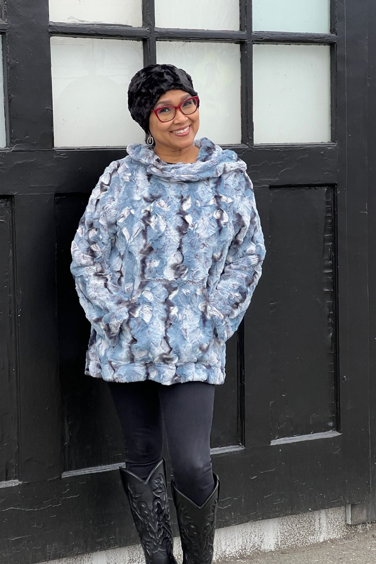 Woman wearing a Hooded Lounger in Rainier Sky, with the hood up. Handmade by Pandemonium Millinery in Seattle, WA, USA.