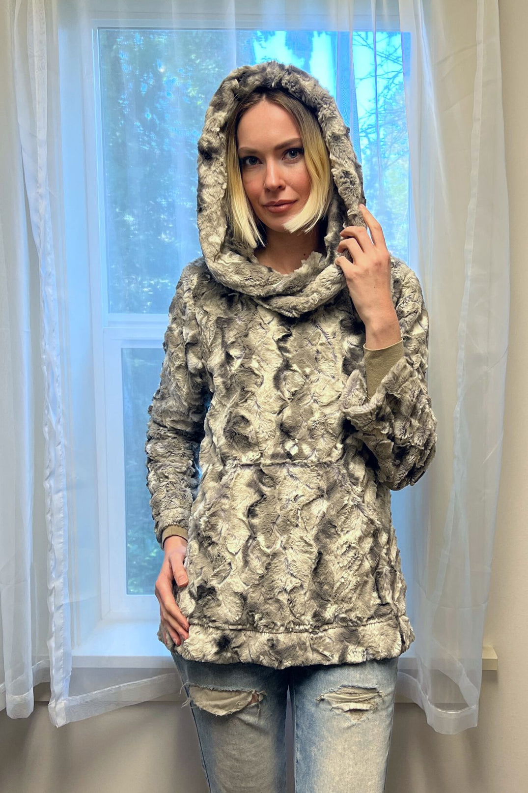 Woman wearing a Hooded Lounger in White Water, with the hood up. Handmade by Pandemonium Millinery in Seattle, WA, USA.