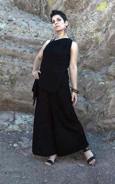 Model wearing South West Gaucho Pants in Crepe Sandstone with Mezcal Cocoon Top standing by water. Leigh Young Collection.