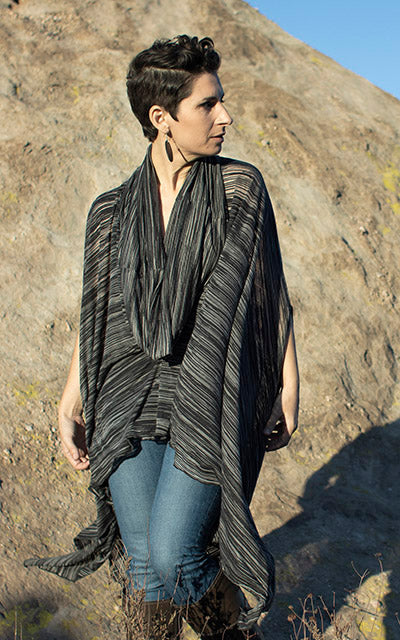 Model is wearing the Badlands Cloak Reflections in Midnight, with hood down. Leigh Young Collection