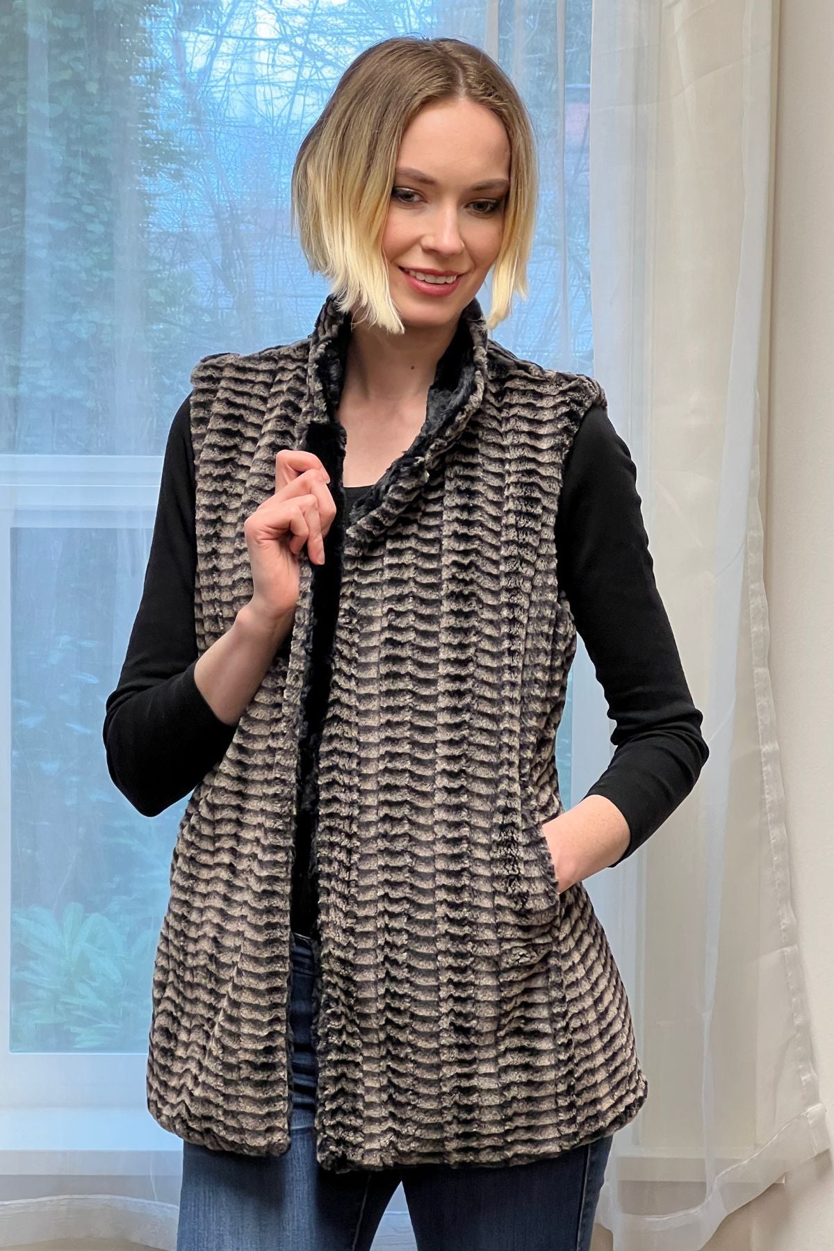 Woman wearing a Mandarin Vest Short style in 8mm Sepia color with Cuddly Black Faux Fur. Reversible. Made in Seattle, WA, USA by Pandemonium Seattle.