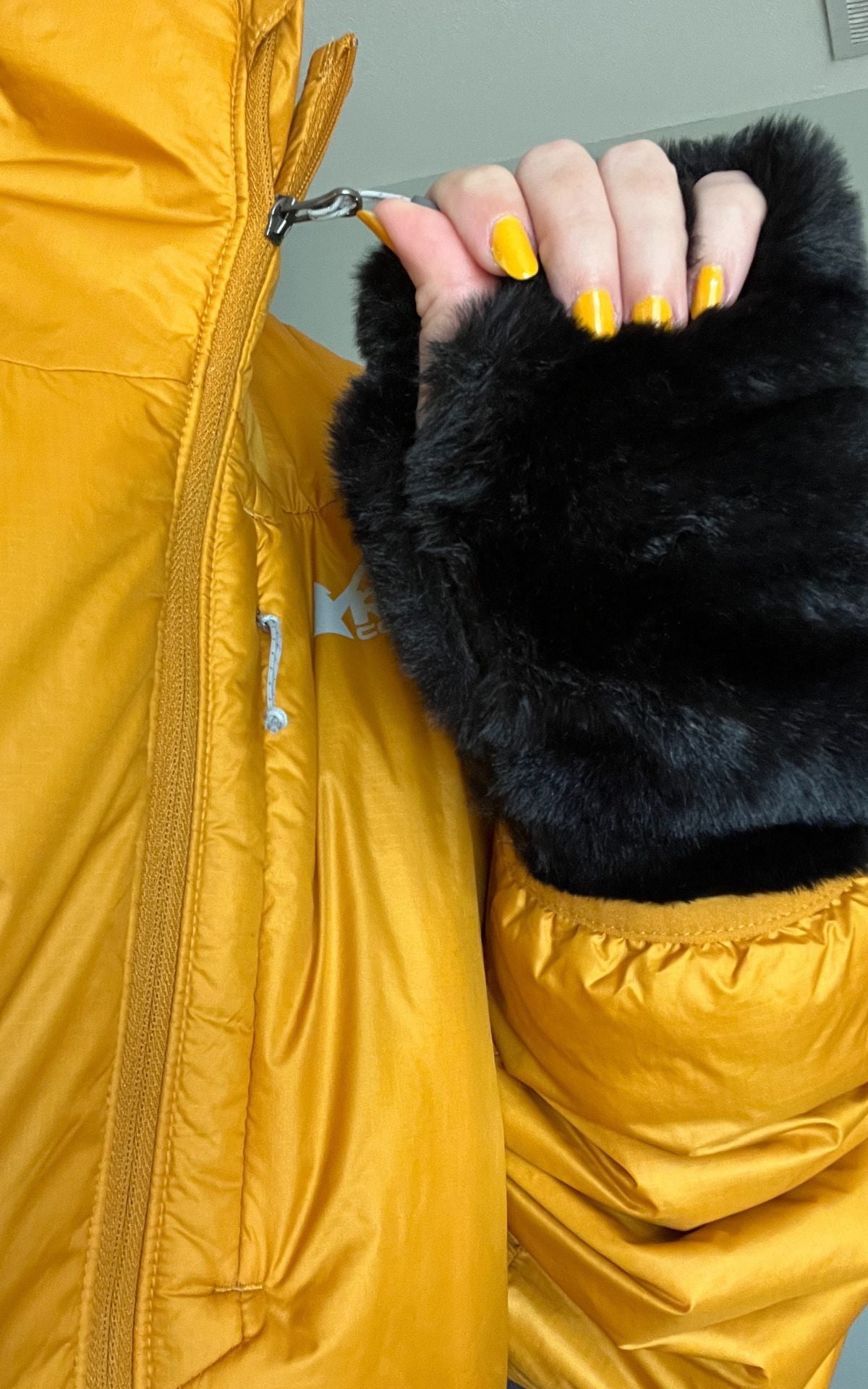 Woman wearing a puffer jacket with Royal Opulence Onyx Faux Fur Fingerless Gloves. Made in Seattle, WA, USA. Pandemonium Seattle.