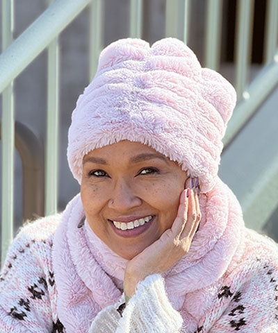 Woman wearing  the Royal Opulence Beanie Faux Fur in Rosé (pink) . Made In Seattle Washington
