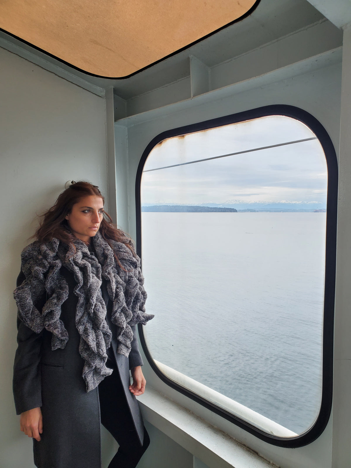 Women looking out of ferry boat window wearing four Scrunchy Ruffled Scarves | Nimbus faux fur in blacks and creams k | Handmade in Seattle WA | Pandemonium Millinery