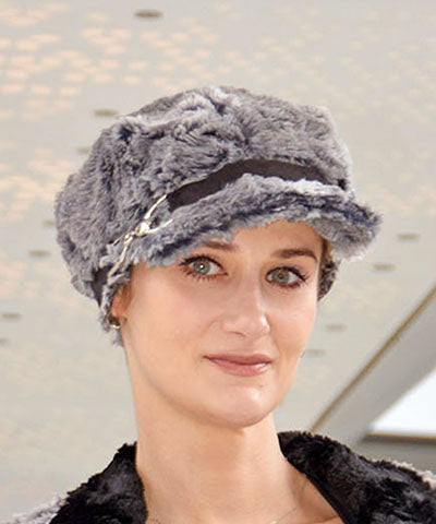 Model wearing Valerie Cap in Seattle Sky Faux Fur with faux suede against orange wall in Handmade in USA by Pandemonium Millinery