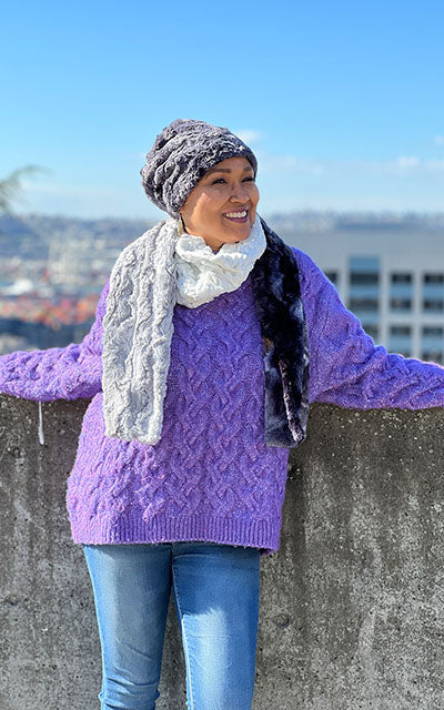Women in front of the Seattle skyline wearing the Color Block Scarf | Winter River, Highland in Skye, and Winter Forst Faux Fur a mix of creams, blues, whites, and Chocolates | Handmade in Seattle WA Pandemonium Millinery