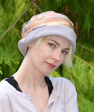 Woman wearing Ana Hat in Rose Quartz Linen with Bayberry Coastal Garden Side Ruching Handmade by Pandemonium Seattle