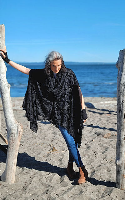 Model at beach in Badlands Cloak in Black Hole Celestial Trellis by Leigh Young Collection handmade in Seattle WA