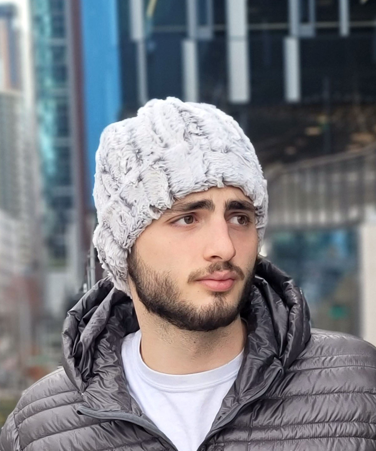Man wearing Beanie in Khaki faux fur, in a side view. Handmade by Pandemonium Seattle.