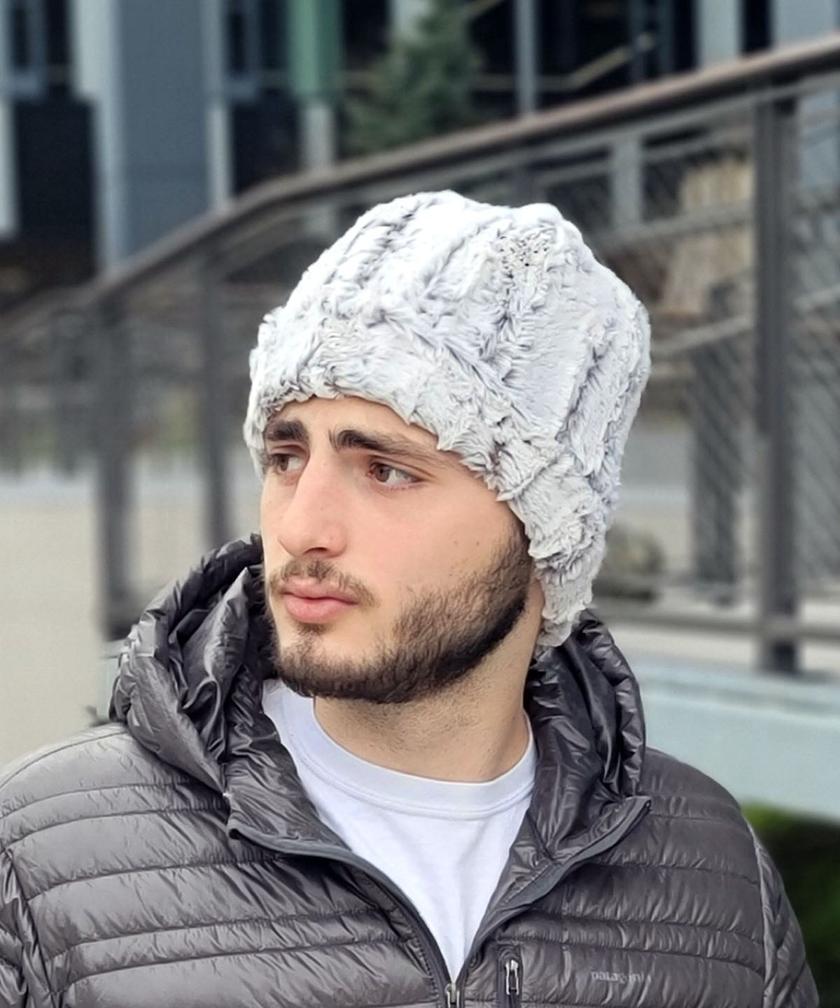 Man wearing Beanie in Khaki faux fur, in a side view. Handmade by Pandemonium Seattle.
