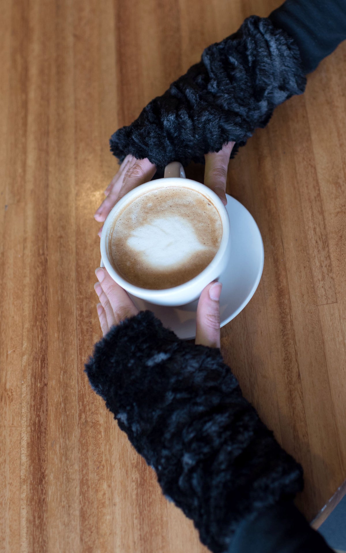 Fingerless Gloves  modleing holding a cup of  coffee| Cuddly Black Faux Fur | Handmade by Pandemonium Millinery Seattle, WA USA
