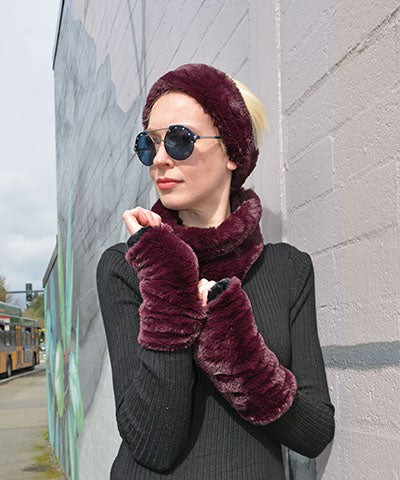 Woman wearing Royal Opulence Fingerless Gloves in Merlot and matching Ear Neck Cozy in Merlot. Made in Seattle, WA, USA. Pandemonium Seattle.