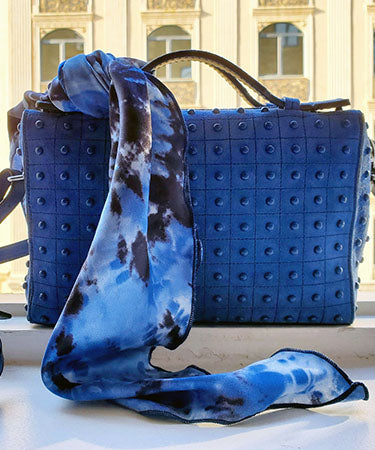 Product shot of Foulard Euro Scarf 21" square tied on a blue handbag | Egyptian Mirage, black, Blues, and ivory tie-dye | Handmade in Seattle WA | Pandemonium Millinery