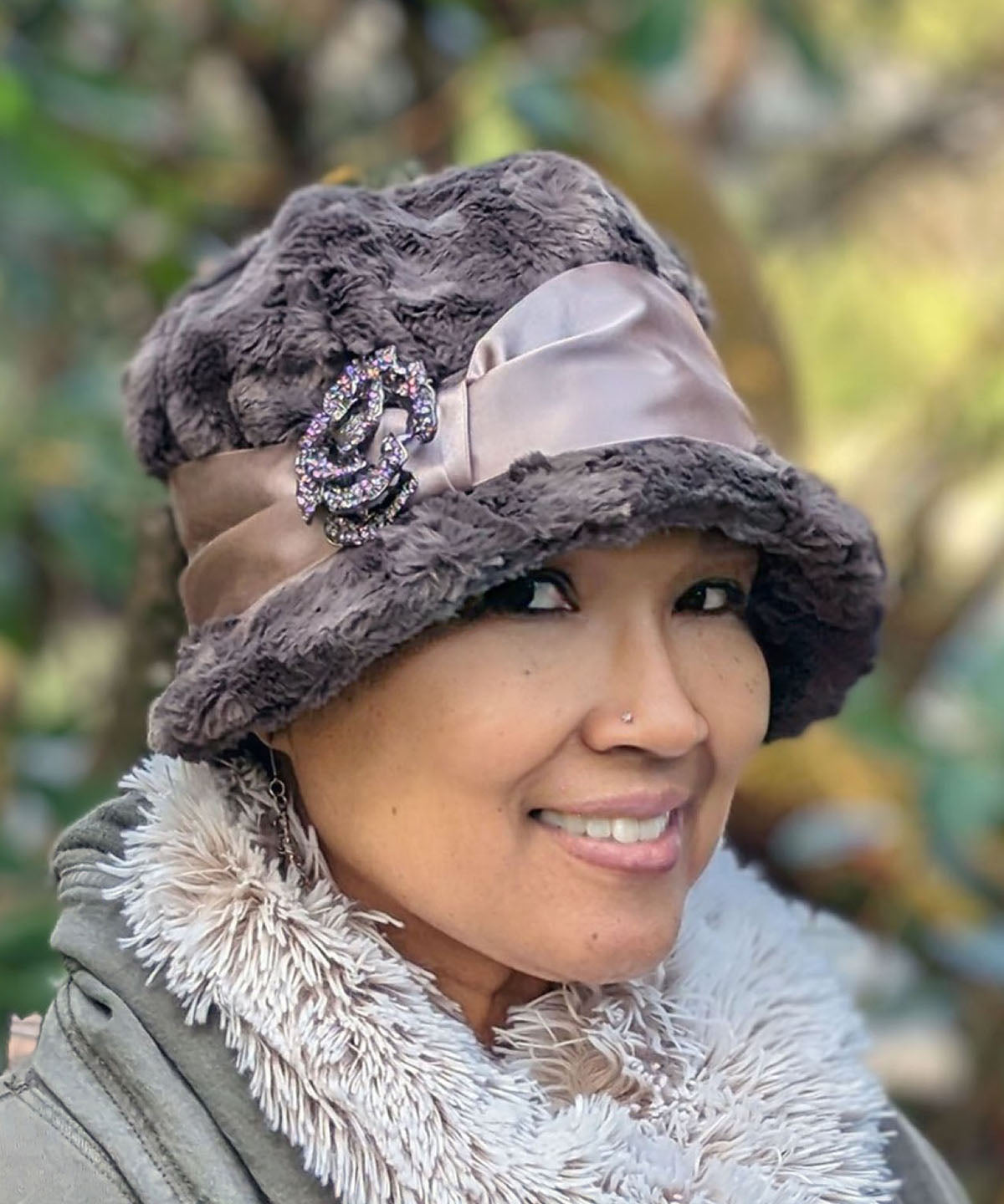 Close up of Woman wearing Grace Cloche Hat in Gray Cuddly Faux Fur with Champagne Satin Sash and Rhinestone Flower Feather Brooch | Handmade in Seattle WA | Pandemonium Millinery