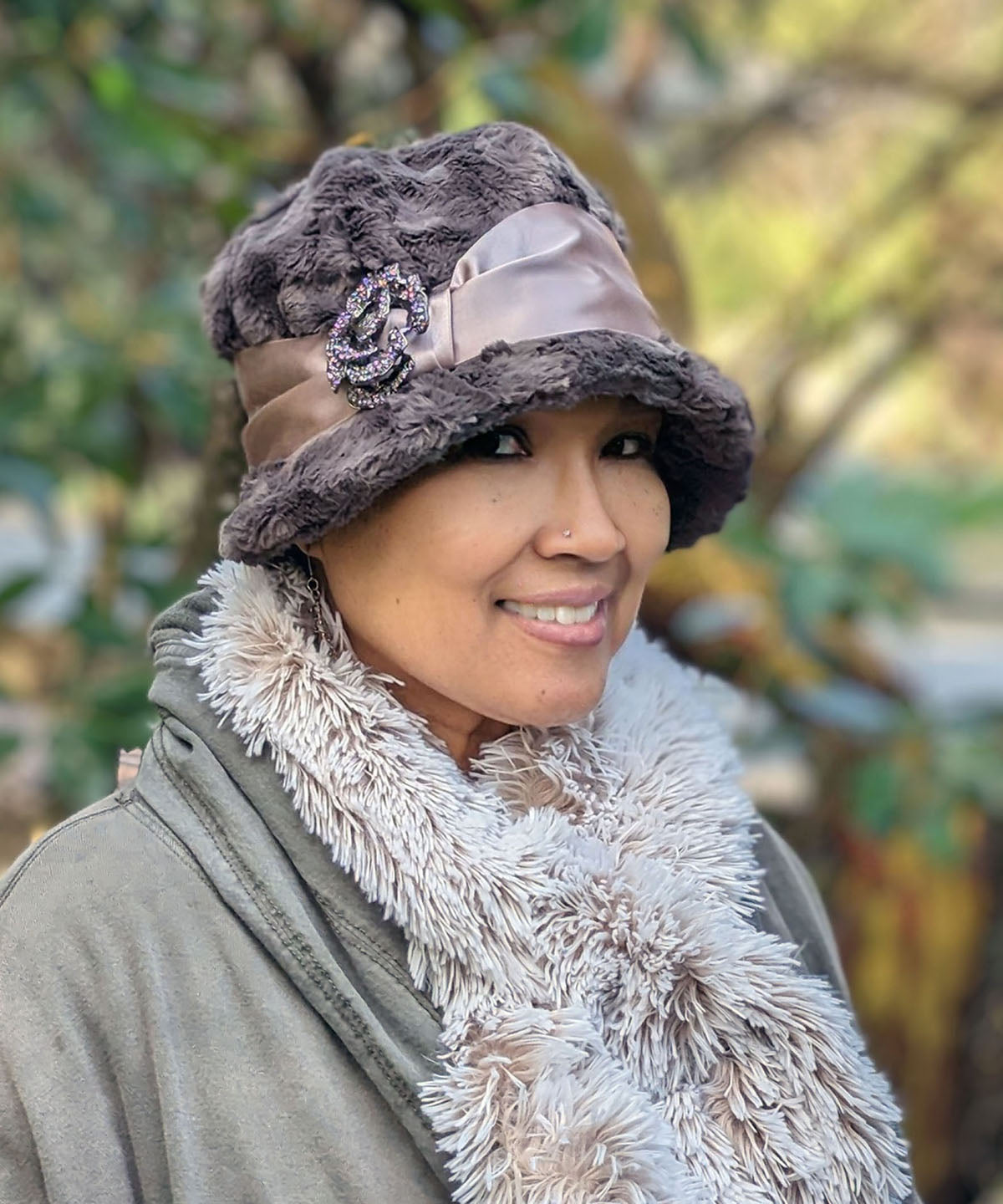 Model wearing a Grace 1920s Cloche Style Hat in Gray Cuddly Faux Fur with Champagne Satin Sash and Rhinestone Flower Feather Brooch | Handmade in Seattle WA | Pandemonium Millinery