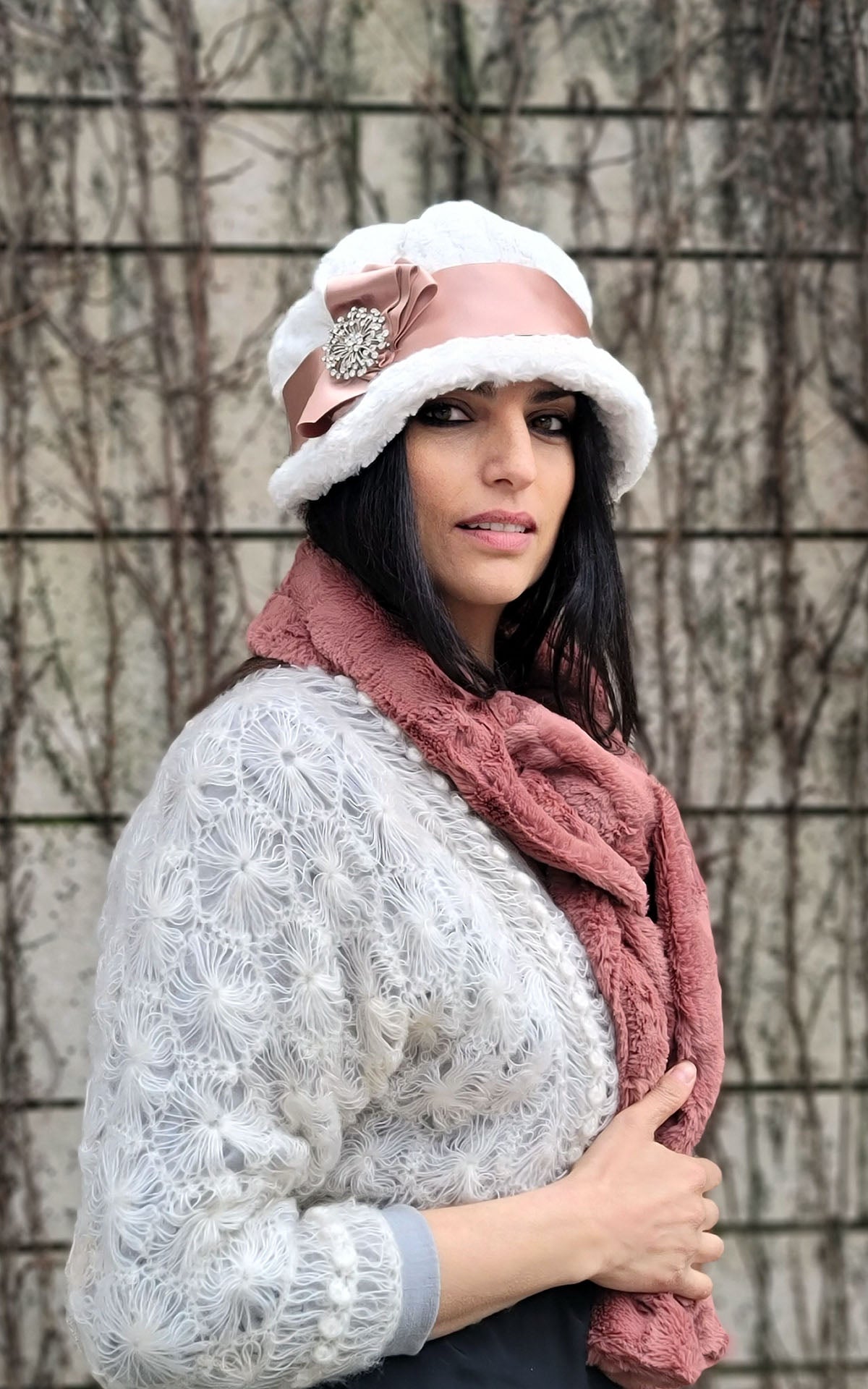  Woman wearing Grace Cloche Style Hat in Cuddly Faux Fur Ivory featuring Apricot Satin and Three Fold Bow with Rhinestone Brooch | Handmade By Pandemonium Seattle | Seattle WA USA