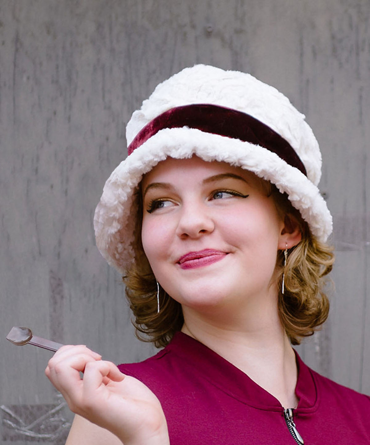 Woman wearing Grace 1920s Cloche Style Hat in Cuddly Faux Fur Ivory featuring Midori Velvet Crimson Band | Handmade By Pandemonium Seattle | Seattle WA USA
