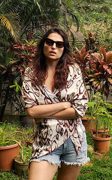  Women outdoors in front of plants wearing sunglasses and large Handkerchief Scarf, Wrap | Crystal Raindrops in Mahogany, ring pattern in dark rust and off-white | Handmade in Seattle WA | Pandemonium Millinery