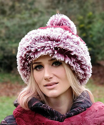 Woman modeling Beanie Hat reversible in Cherry Cordial and Cranberry Fox Faux Fur with Pom. Handmade by Pandemonium Millinery in Seattle, WA.